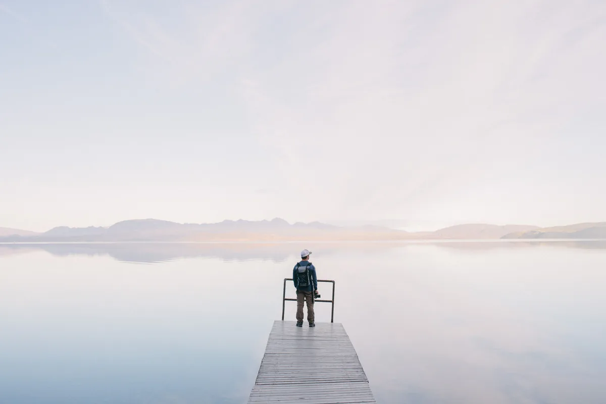 Person inspecting a waterfront jetty